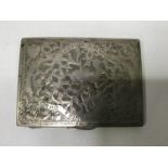 A continental .800 grade silver cigarette case, the front ornately decorated with a deer amidst