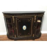 An ebonised Victorian Credenza with gilt-metal mounts, the central door with oval 'Sevre' style