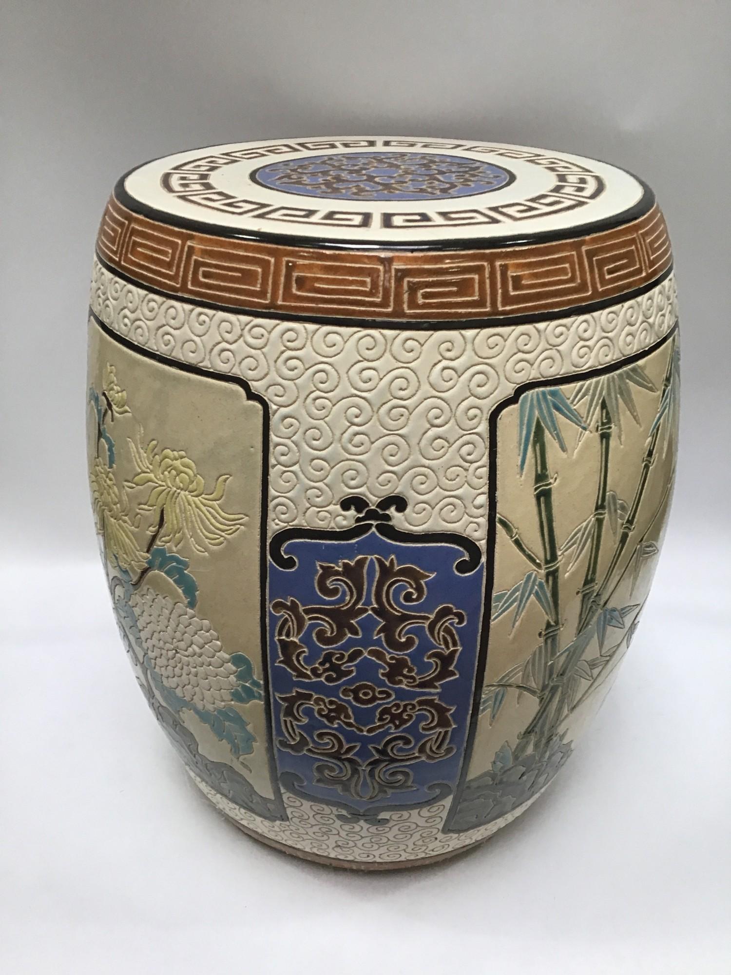 A modern Oriental barrel seat decorated with flowers, bamboo and geometric design to cream ground,