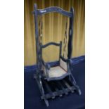 A Victorian fairground 'style' doll's swing chair, the wooden frame painted black with lined detail,