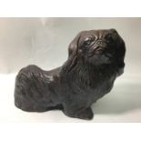 A large composite figure of a Pekingese, 35cm wide, together with an Oriental blue and white
