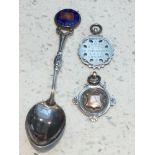A silver and enamel spoon RMS Aquitania, and two gold and silver sports medals from RMS Olympic,