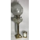 A Victorian oil lamp, with brass classical column supporting a cut glass reservoir, etched glass