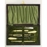 A late 19th century sewing kit comprising various bone handled sewing accessories and a silver cased