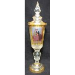 A Bohemian clear and amber glass goblet and cover, the reserve hand-painted with two ladies, with