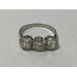 A platinum three-stone diamond ring, claw set with old-cut diamonds, the diamonds weighing a total