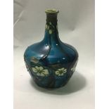 A Minton 'secessionist' posy vase, shape no. 33, decorated with cream flowers to blue ground, 12cm