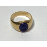 An 18ct gold gent's intaglio signet ring, set with an oval lapis lazuli engraved with two