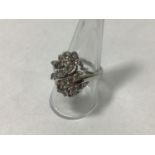 A 14ct white gold twist design cluster ring, claw set with twenty six round brilliant-cut