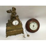 A circular aneroid barometer housed in an oak frame carved with a continuous band of flowers and