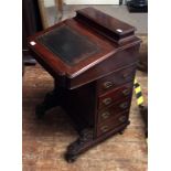 A Victorian mahogany Davenport, with raised back above a sloped top with gilt-tooled, green