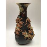 A Japanese Sumida Gawa vase, of baluster form, drip glazed neck, applied with two groups of climbing