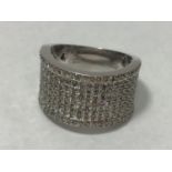 An 18ct white gold wide band ring, claw set with eight rows of round brilliant-cut diamonds, the two