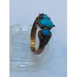 An 18ct gold turquoise dress ring, set with three oval turquoise stones in a rub over setting,