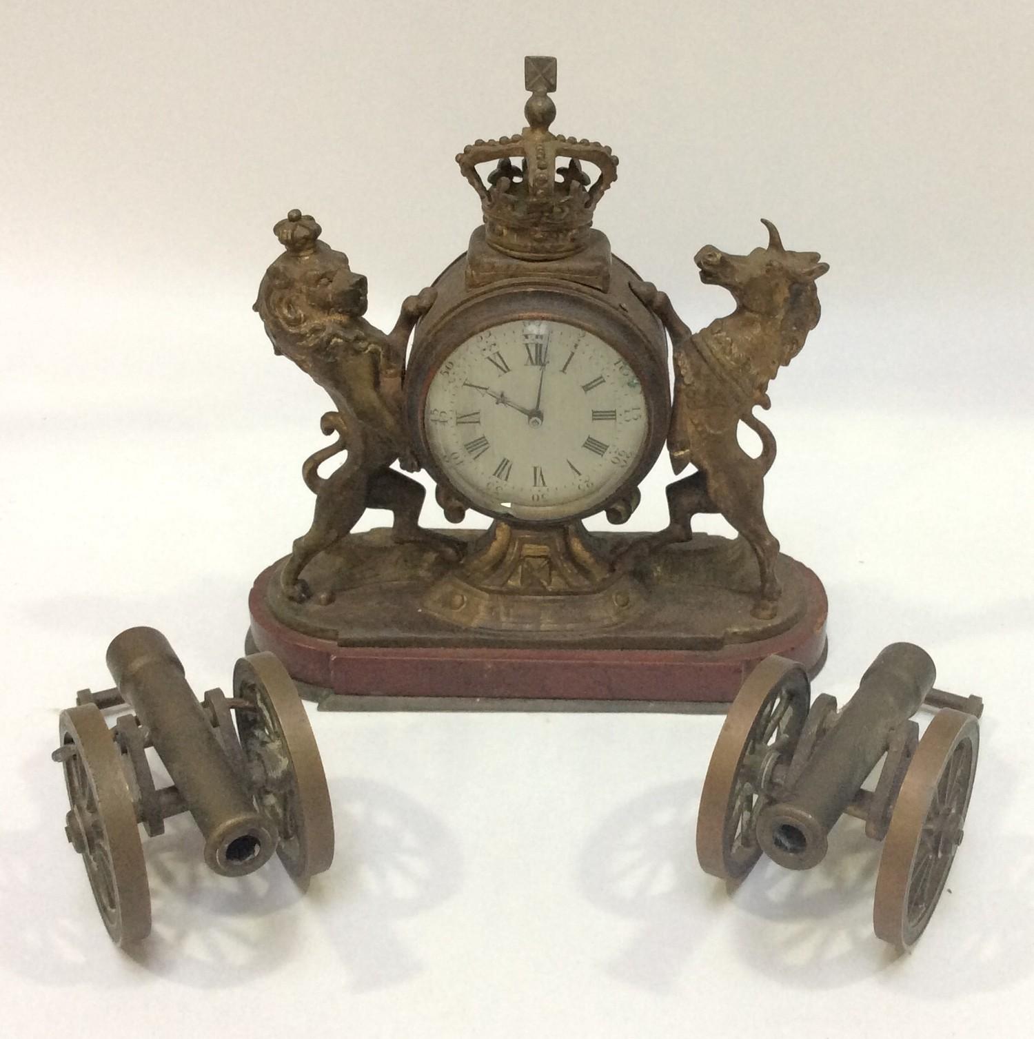 A small gilt brass mantel clock modelled as the Lion and Unicorn from the Royal Coat of Arms,