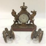 A small gilt brass mantel clock modelled as the Lion and Unicorn from the Royal Coat of Arms,