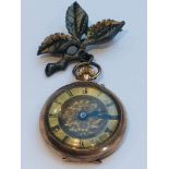 A 9ct rose gold open face lady's pocket watch, roman numeral dial. Total weight including metal leaf