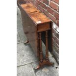 A Victorian burr-walnut drop-leaf Sutherland table, with turned trestle ends, and brass sabot