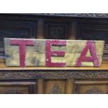 A vintage 'Tea' sign with red painted metal letters on oak plinth, 79cm wide