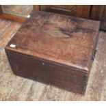 An 18th century elm trunk with black metal handles and dovetail joints, central inlaid diamond,