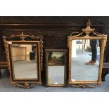 A gilt framed rectangular mirror with urn finial and scrolling swags, label to verso re purchase