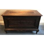 A 19th century oak-lined mahogany Cassone, the hinged top, front and sides carved with cartouches