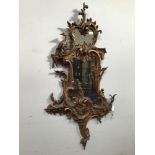 A George III Chippendale style finely carved giltwood rococo wall mirror with scrolling foliage
