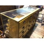 A glazed light oak haberdashery shop counter, with sixteen drawers, 152x59x92cm