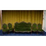 A Victorian mahogany parlour suite comprising sofa and four chairs, each with carved floral