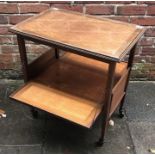 An Edwardian inlaid mahogany drinks/ serving trolley, the 'trellis' inlaid parquetry top above and a
