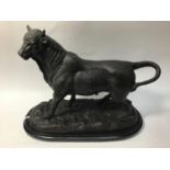A bronze sculpture of a bull, raised on naturalistic base and oval shaped marble plinth, signed 'A.