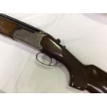 A 12-bore double barrel shotgun by Lanber, with 27.5" inch blued steel over/under barrels, full