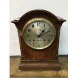 A late 19th / early 20th century mahogany inlaid eight day mantel clock, with arched top, silvered