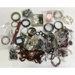 A quantity of costume jewellery including amber coloured necklaces, bracelets and watches etc.