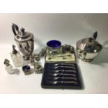 A silver three piece condiment set comprising open salt and mustard with blue glass liners and