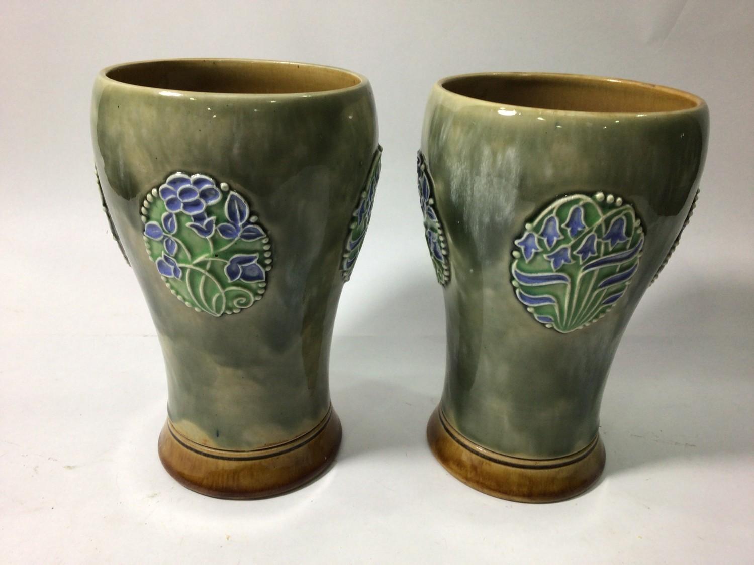 A pair of early 20th century Royal Doulton stoneware vases of tapering baluster form, decorated with