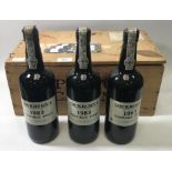 Three bottles of Cockburns 1983 vintage port, each with wax seals to tops (in varying condition)