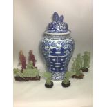 A large Oriental blue and white temple jar and cover with Dog of Fo finial, 49cm high, together with