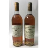 Two bottles of Château Rieussec Sauternes, one a 1984 vintage, the other a 1982, level at base of
