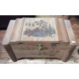 An Oriental carved camphor lined blanket chest, carved with scenes of figures crossing a bridge