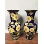 A pair of large Vietnamese floor vases, of baluster form, decorated with yellow and pink flowers