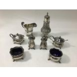 A silver sugar caster of baluster form, with embossed floral and foliate decoration, raised on