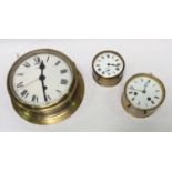 A brass bulkhead clock, the white enamel dial with Roman numerals denoting hours, 22cm diameter,