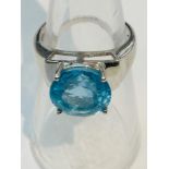 A 9ct white gold set with a round blue topaz stone, measuring 8x8mm, ring weighs 5.2 grams, finger