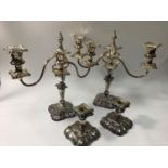 A pair of silver-plated three light candelabra, converting to candlesticks, removable drip pans,