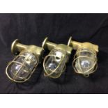 Six reclaimed brass bulkhead ship passageway lights, with Yoshida Tokushu glass globes, 17x23cm
