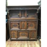 A 17th century and later oak court cupboard, the shaped cornice above an ornately carved frieze with