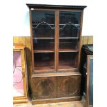 An early Edwardian/late Victorian arts and crafts style two door display cabinet, with moulded