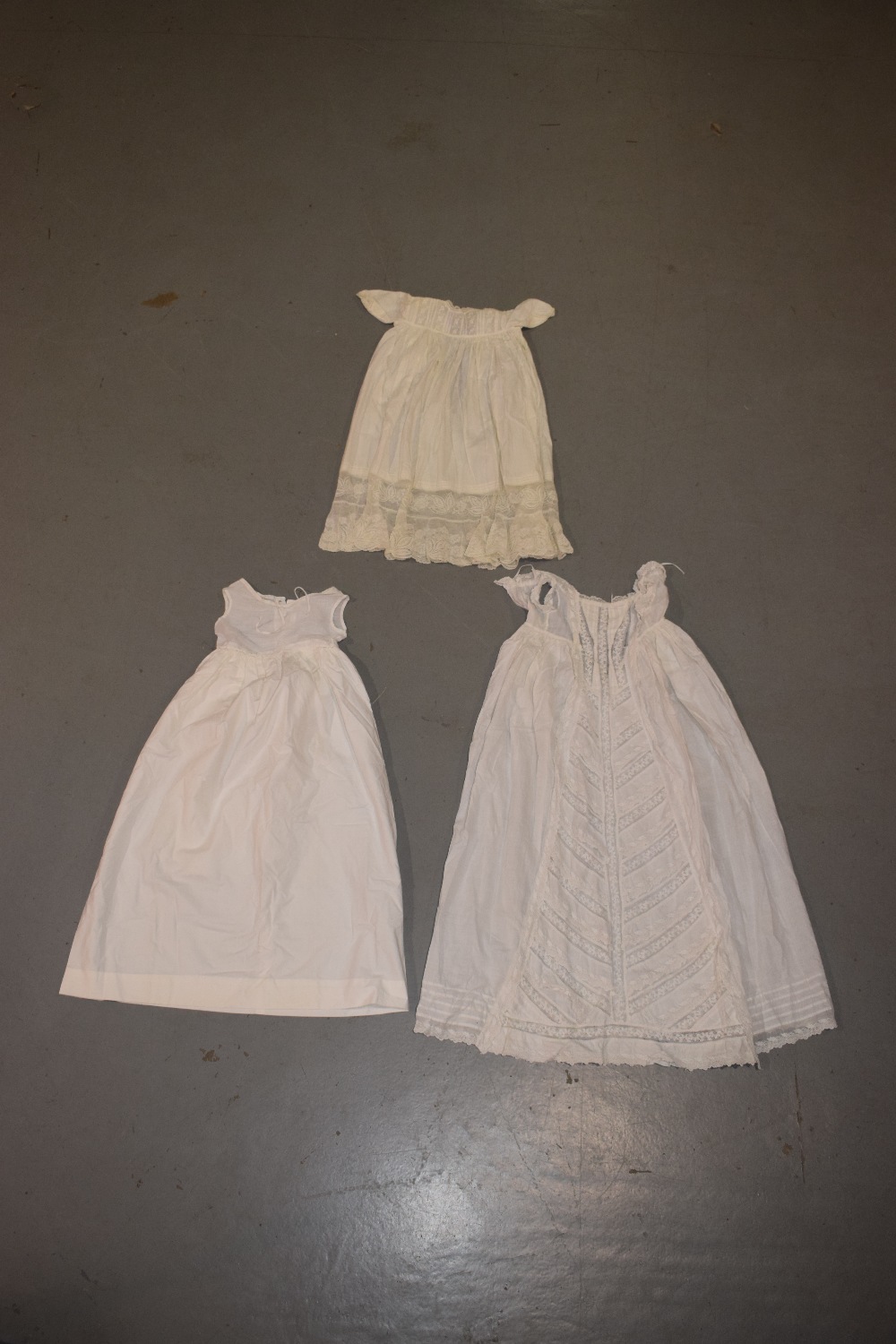 Two fine white cotton christening gowns, one with white embroidered panelled skirt; the other with