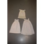 Two fine white cotton christening gowns, one with white embroidered panelled skirt; the other with